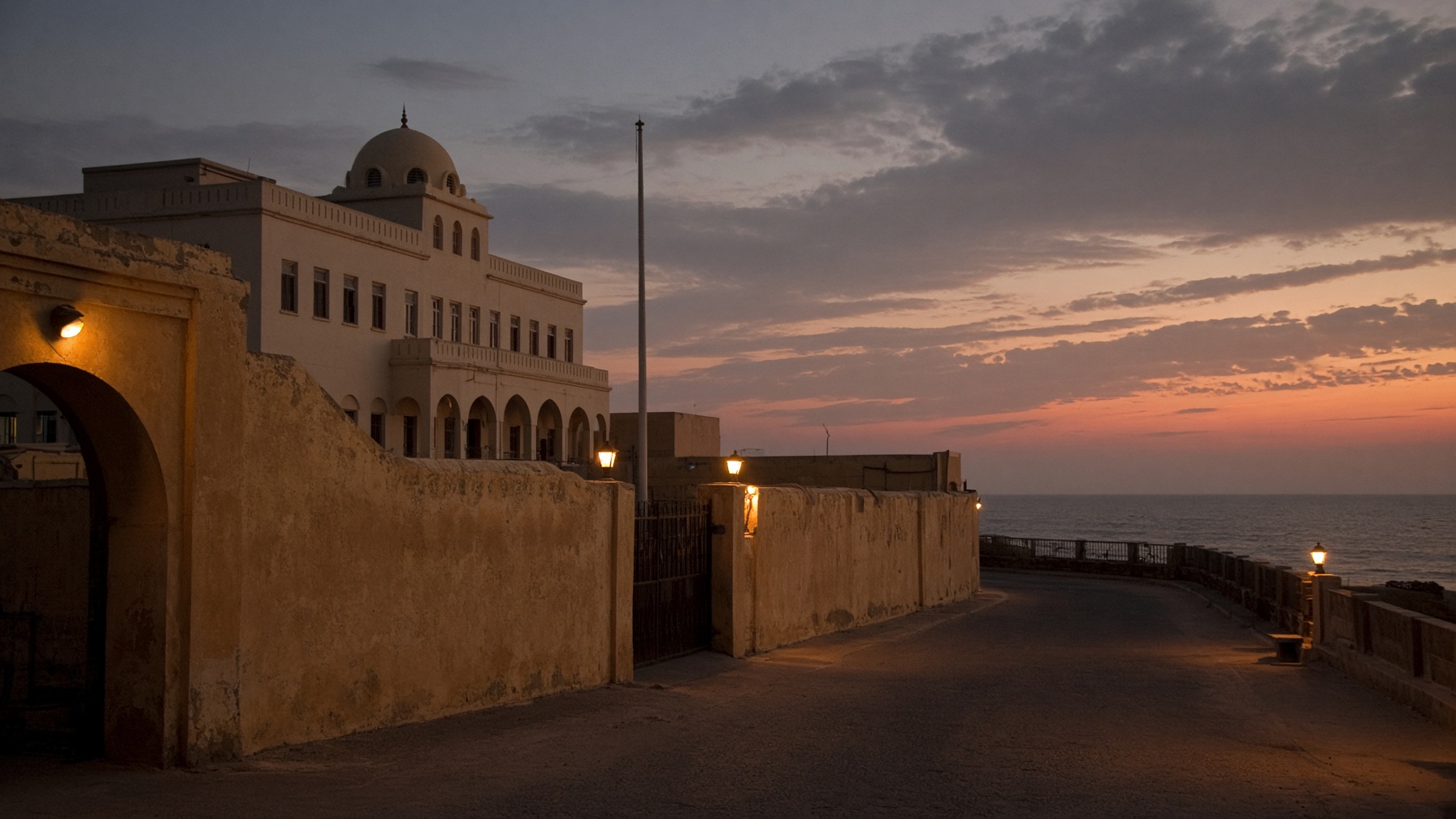 A government compound at dusk, the kind of official façade diplomacy is staged against.