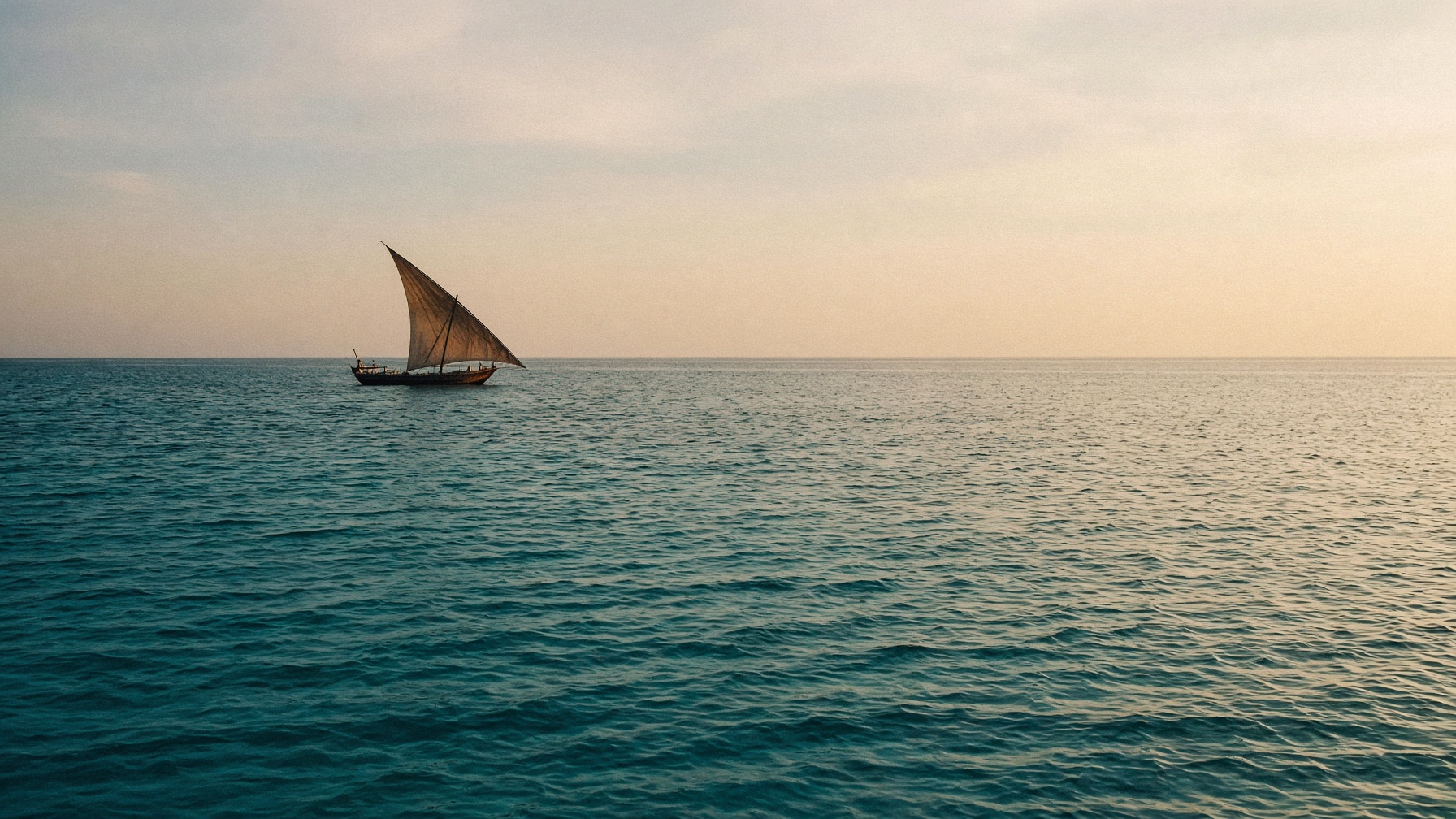 The Indian Ocean off the Horn of Africa, a distant dhow on the water.